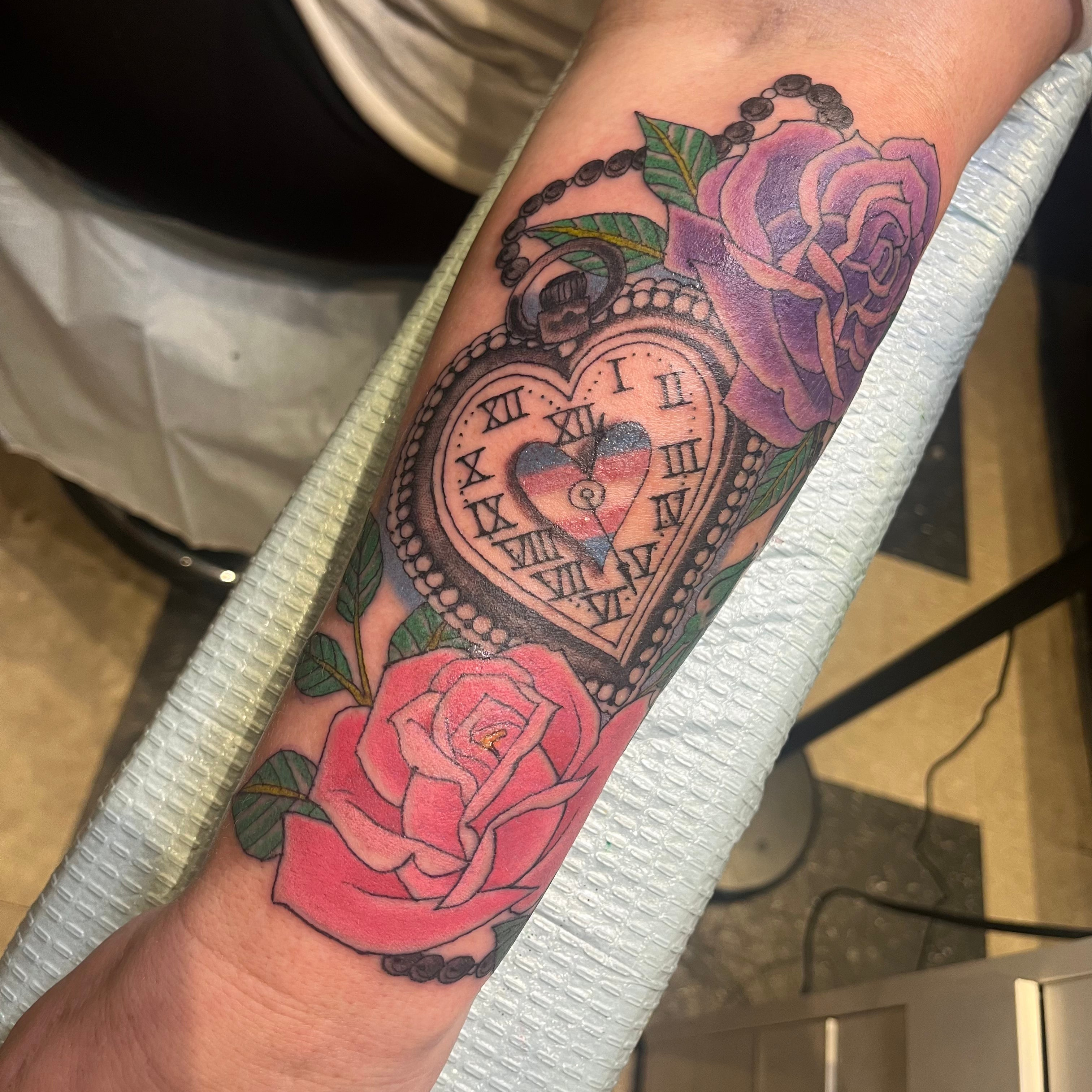 Andrea tattoo of traditional pocket watch and roses