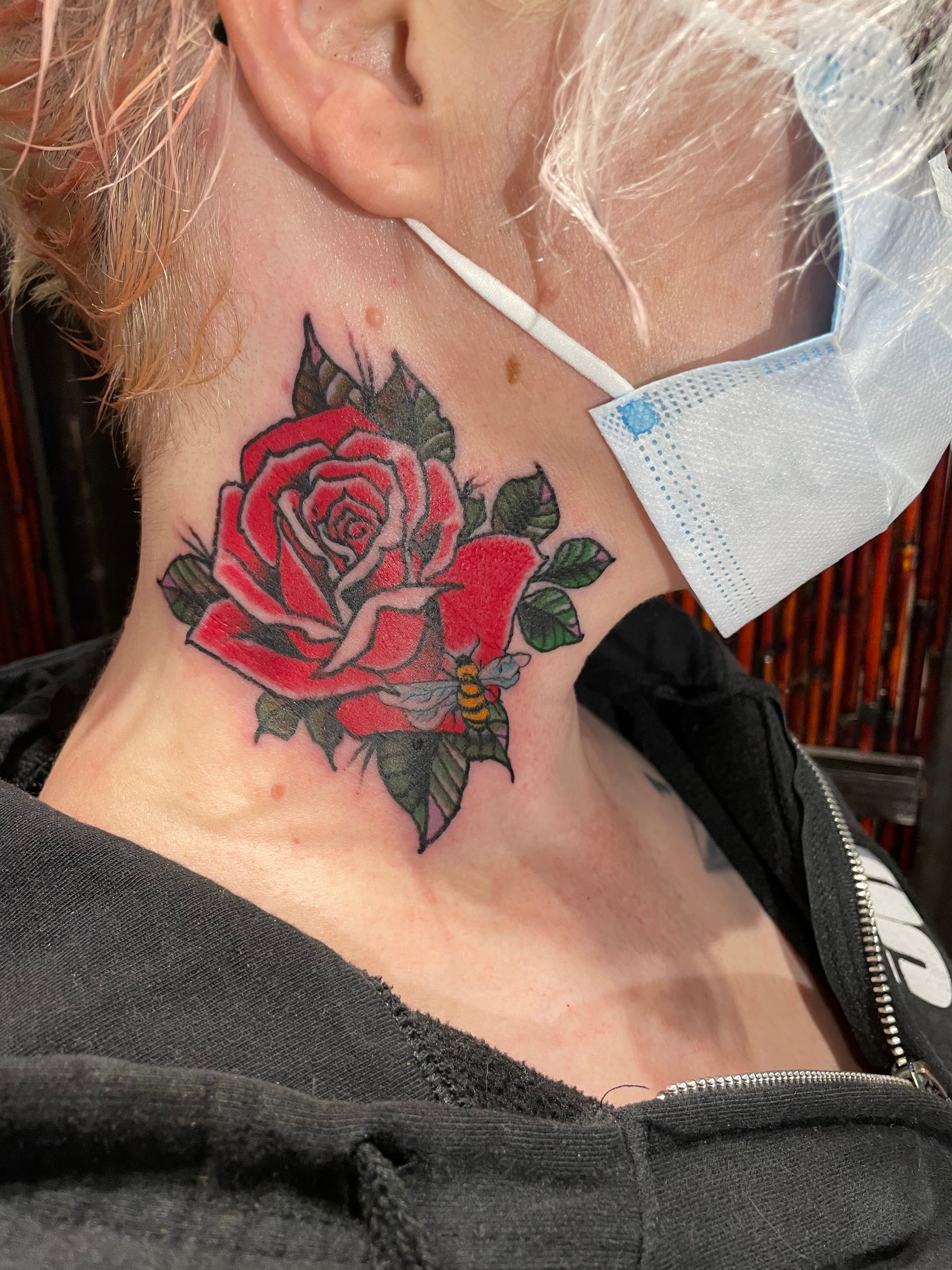 Andrea tattoo traditional rose on the neck